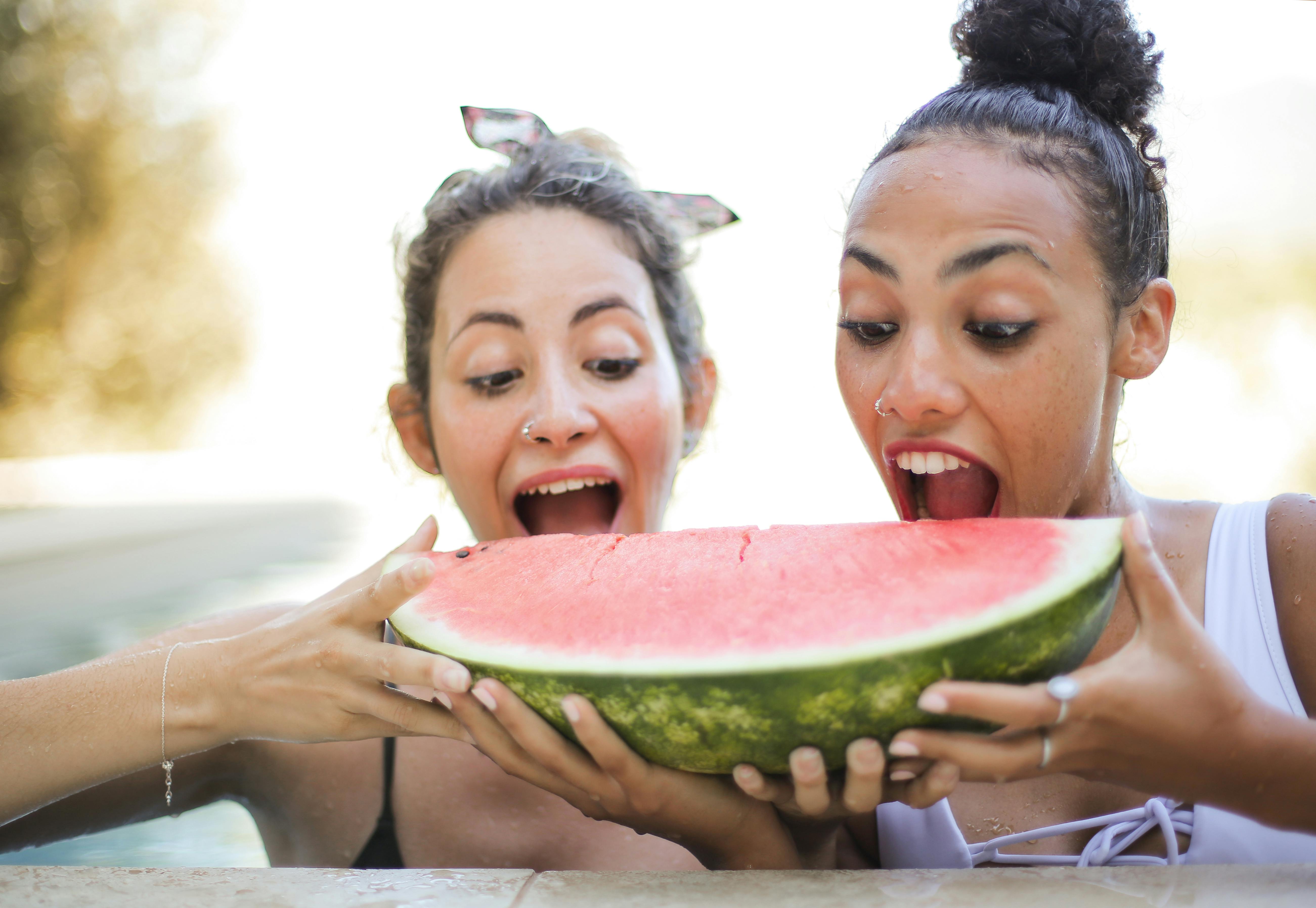 Why people love Charleston Gray Watermelon Two friends sharing Charleston Gray watermelon slices